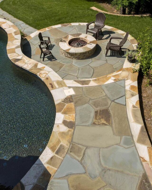Creating outdoor perfection with custom stonework. 🌿✨ Dive into luxury with a stunning poolside patio and cozy fire pit designed by The Stone Man team 🙌 

•
•
•

#StoneManRocks #OutdoorLiving #PatioGoals #CustomStonework #poolsideparadise #charlotte #clt #fortmill